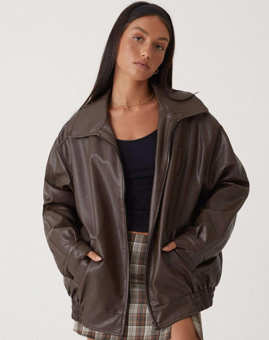 Woman wearing an oversized faux leather bomber jacket