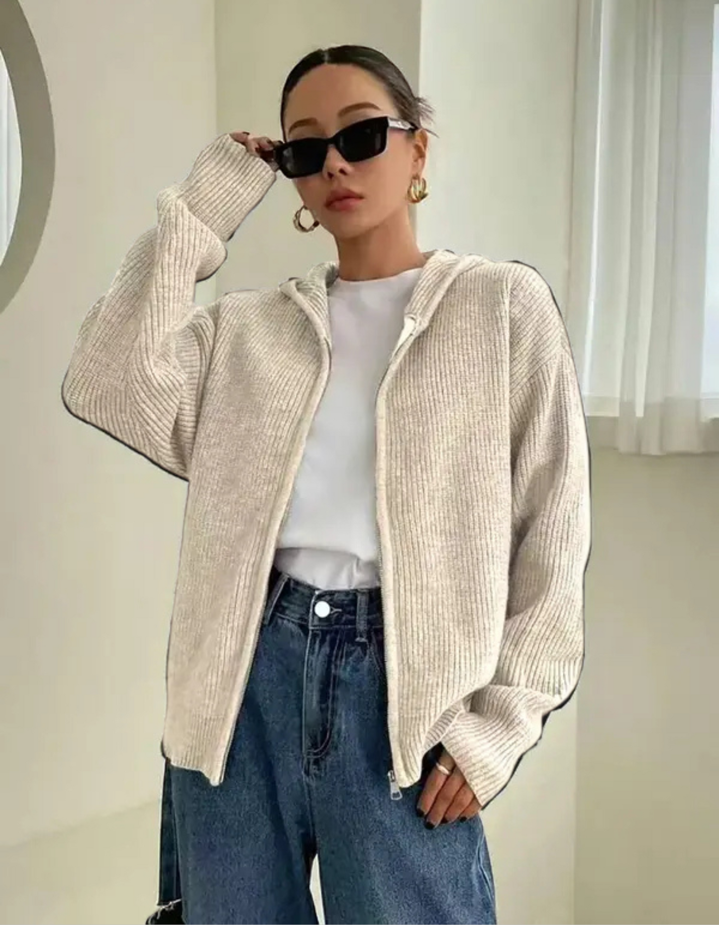 Woman wearing a zip up hooded cardigan