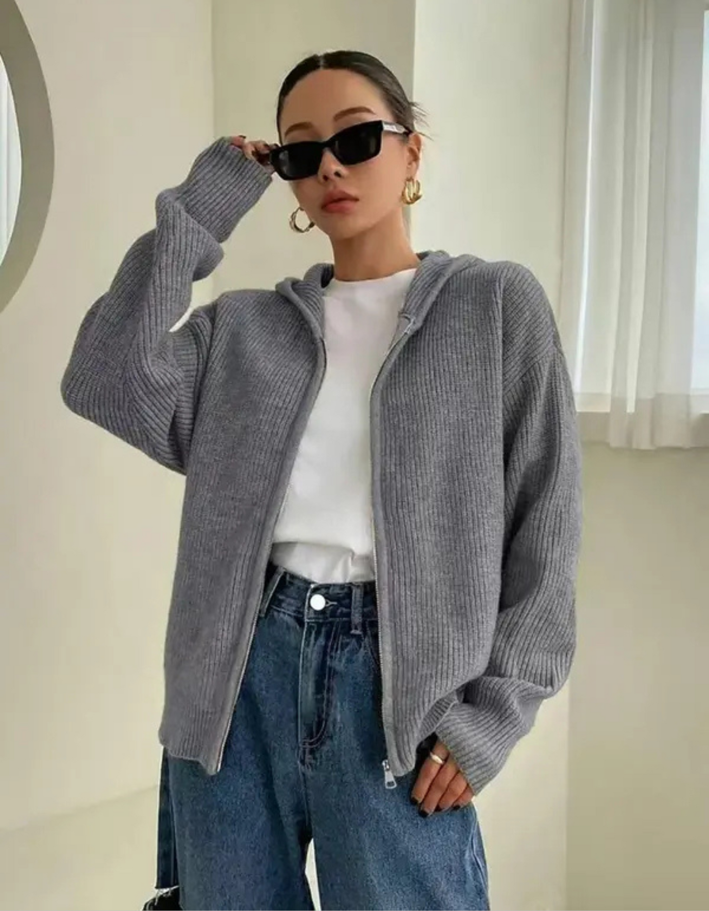 Woman wearing a zip up hooded cardigan
