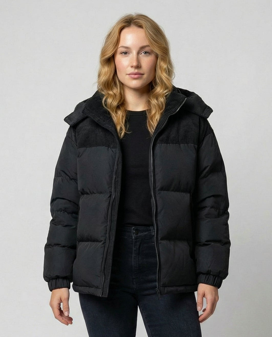 Woman wearing a hooded insulated quilted puffer jacket
