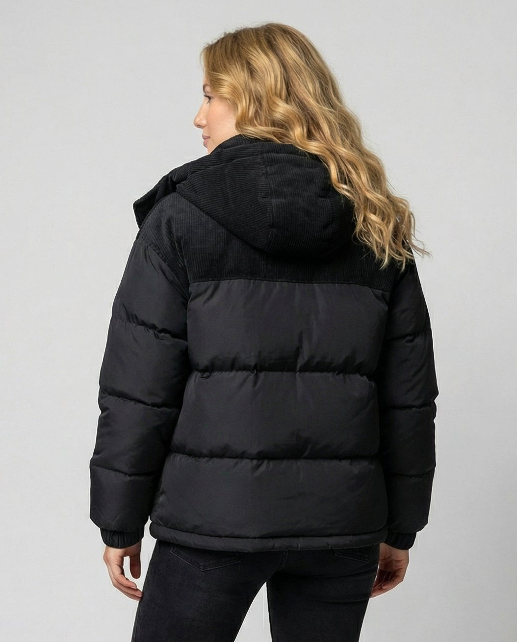 Woman wearing a hooded insulated quilted puffer jacket