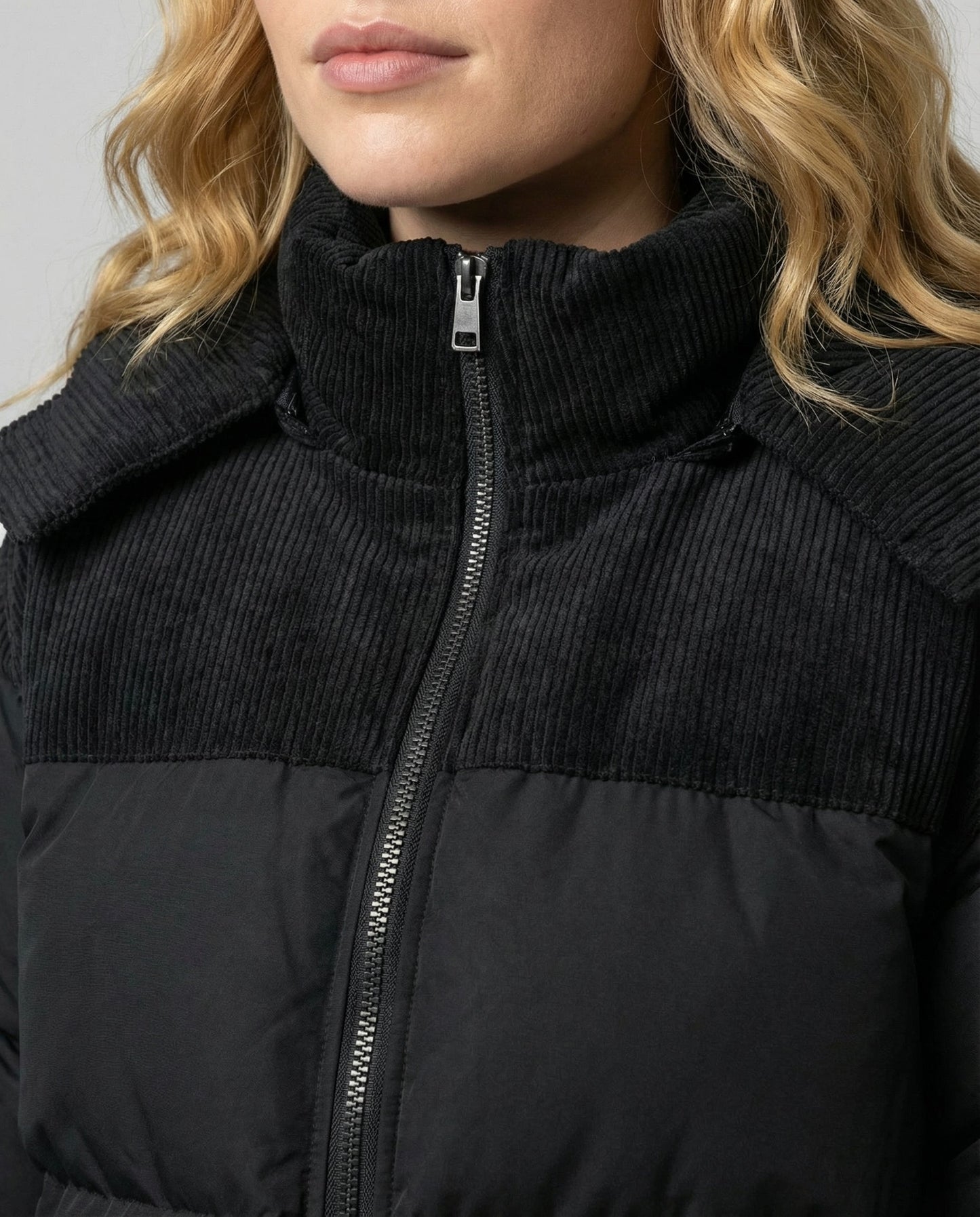 Woman wearing a hooded insulated quilted puffer jacket