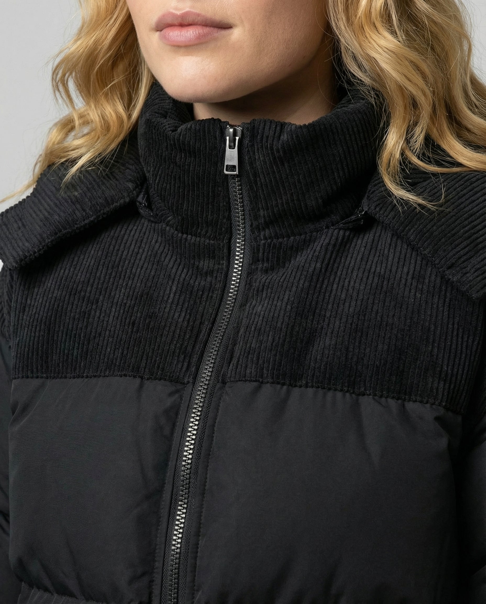 Woman wearing a hooded insulated quilted puffer jacket