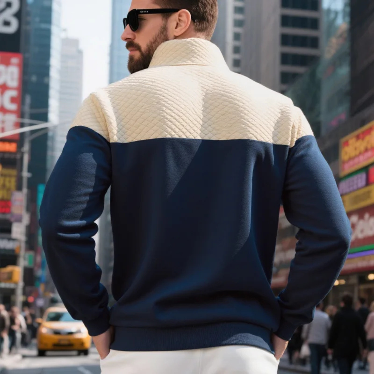 Man wearing a quilted color block half zip sweater