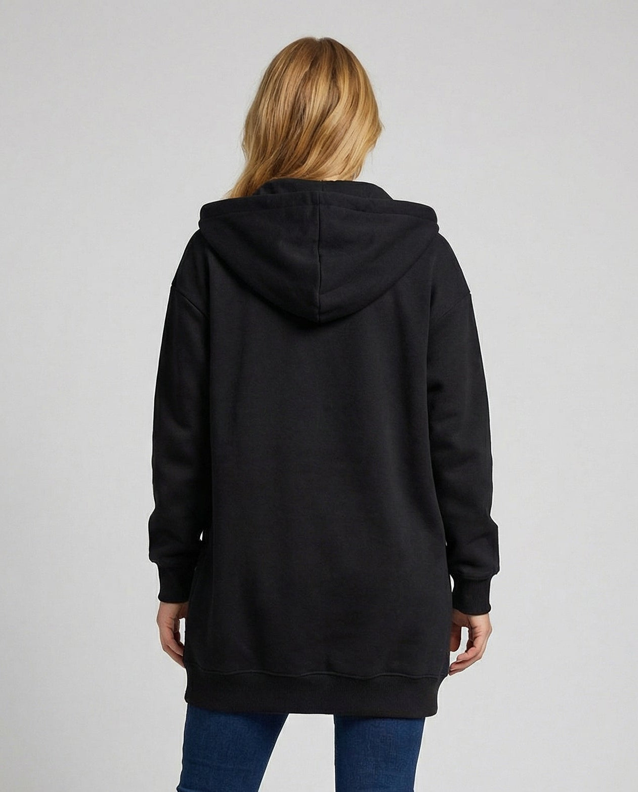 Woman wearing a knee length hooded sweatshirt