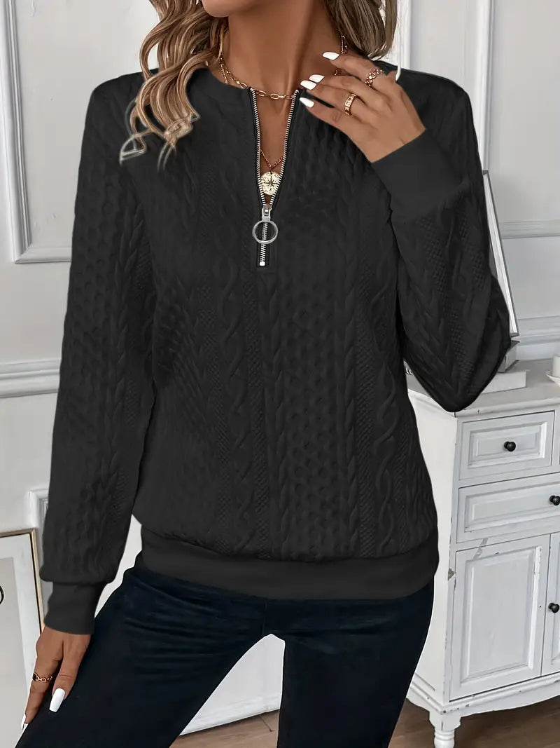 Woman wearing a cable knit quarter zip sweater