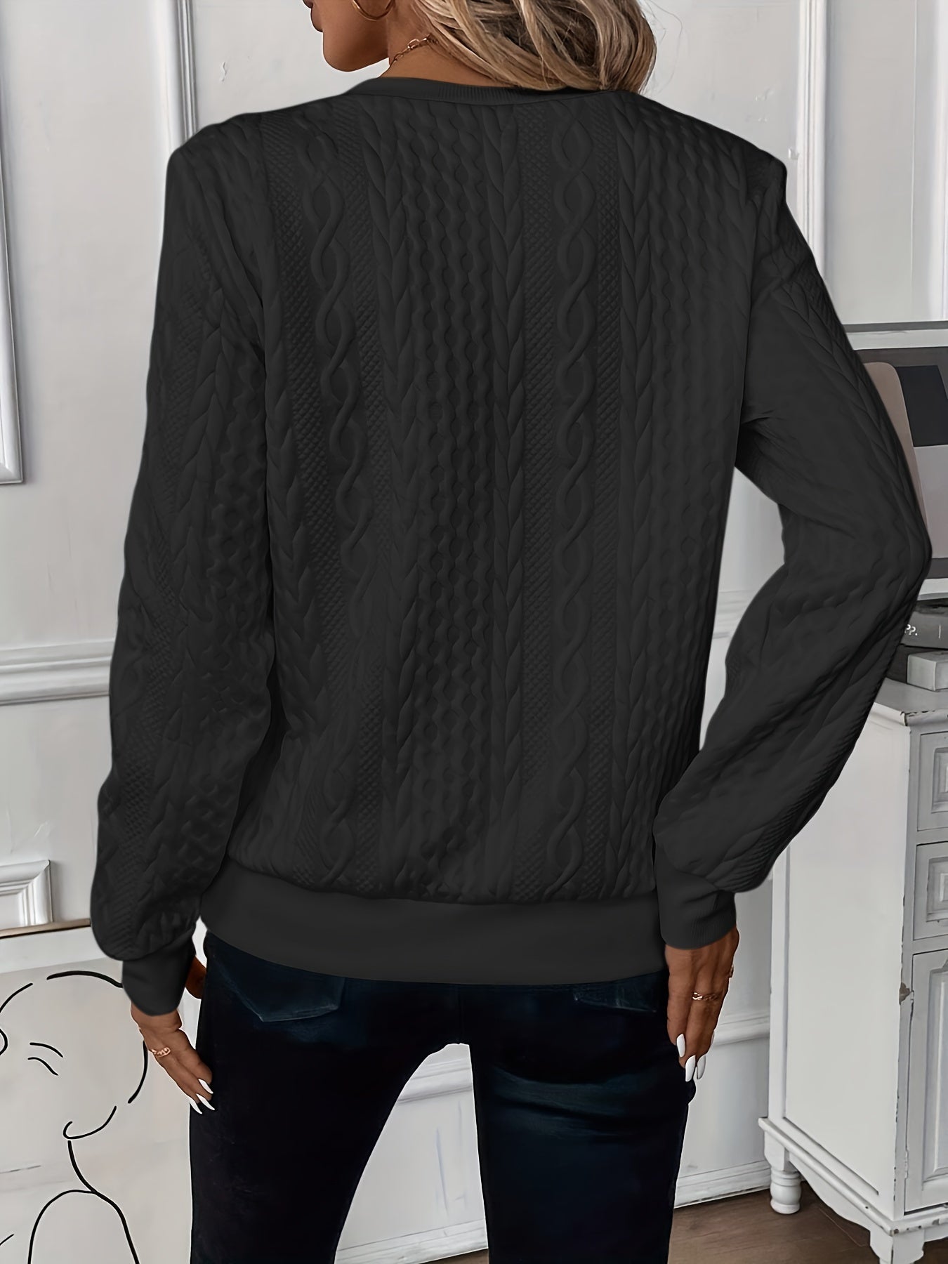 Woman wearing a cable knit quarter zip sweater