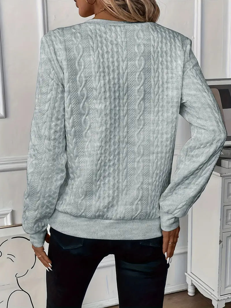 Woman wearing a cable knit quarter zip sweater