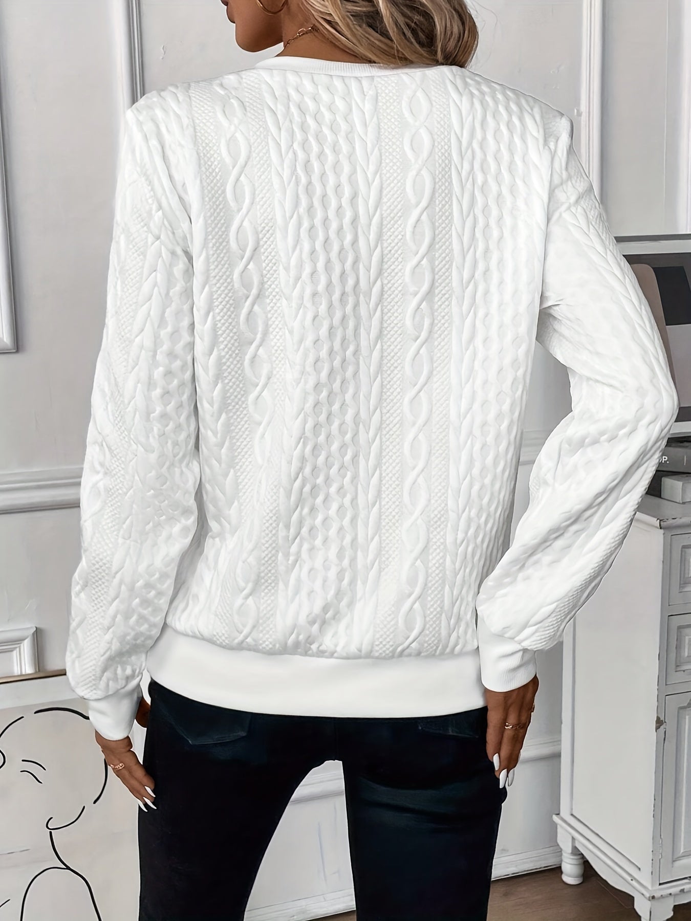 Woman wearing a cable knit quarter zip sweater