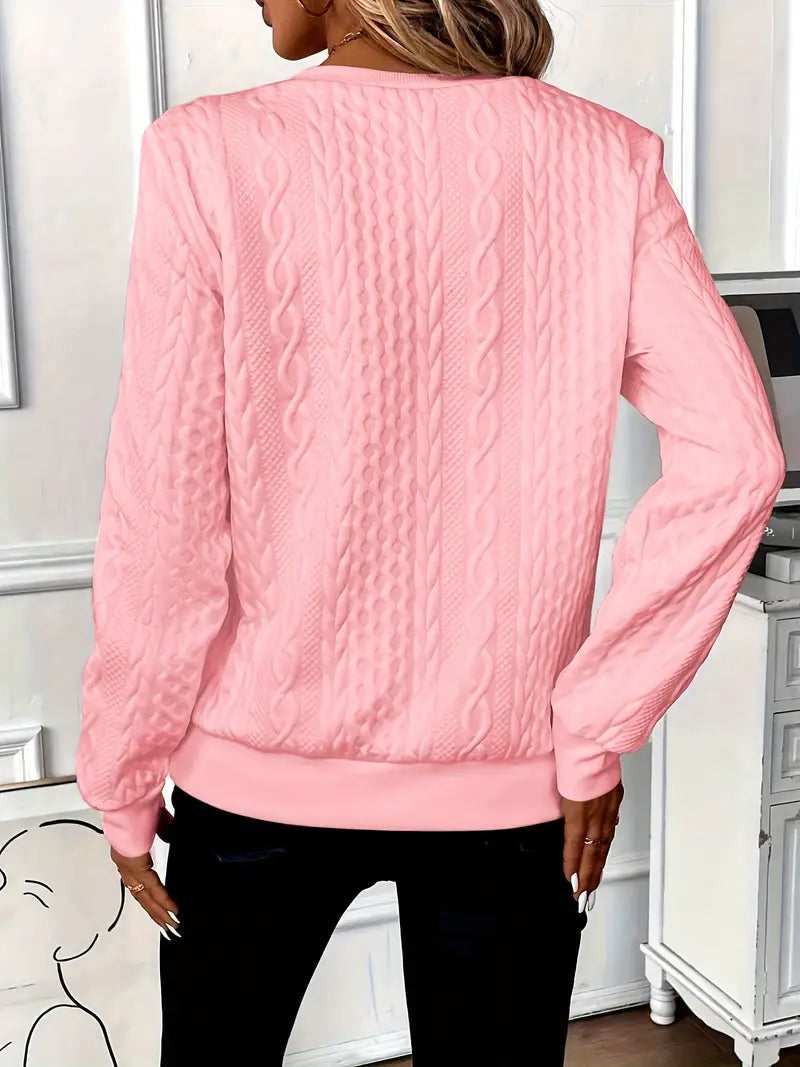 Woman wearing a cable knit quarter zip sweater