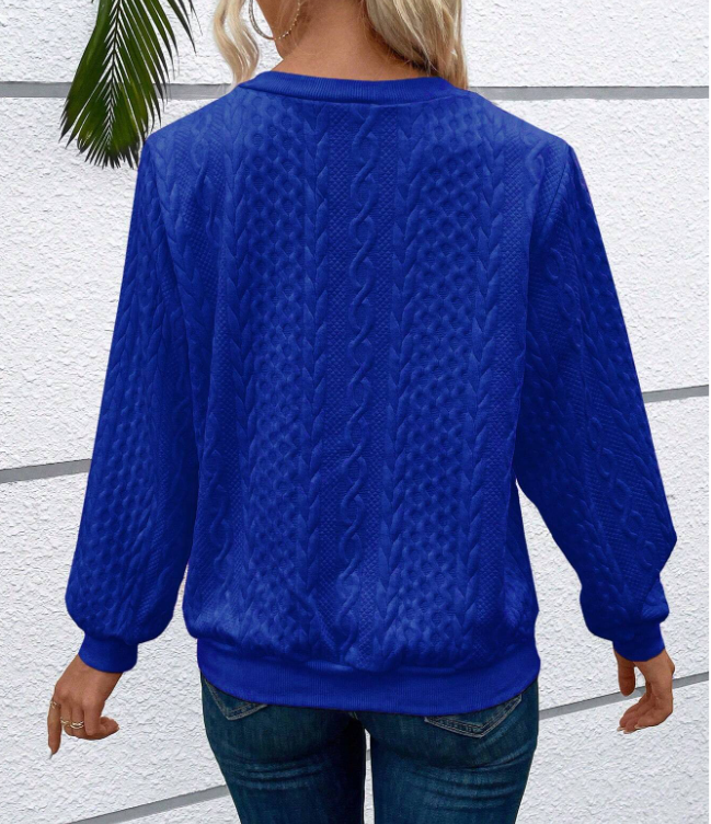 Woman wearing a cable knit quarter zip sweater