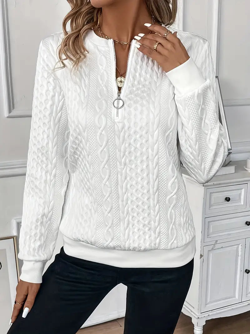 Woman wearing a cable knit quarter zip sweater