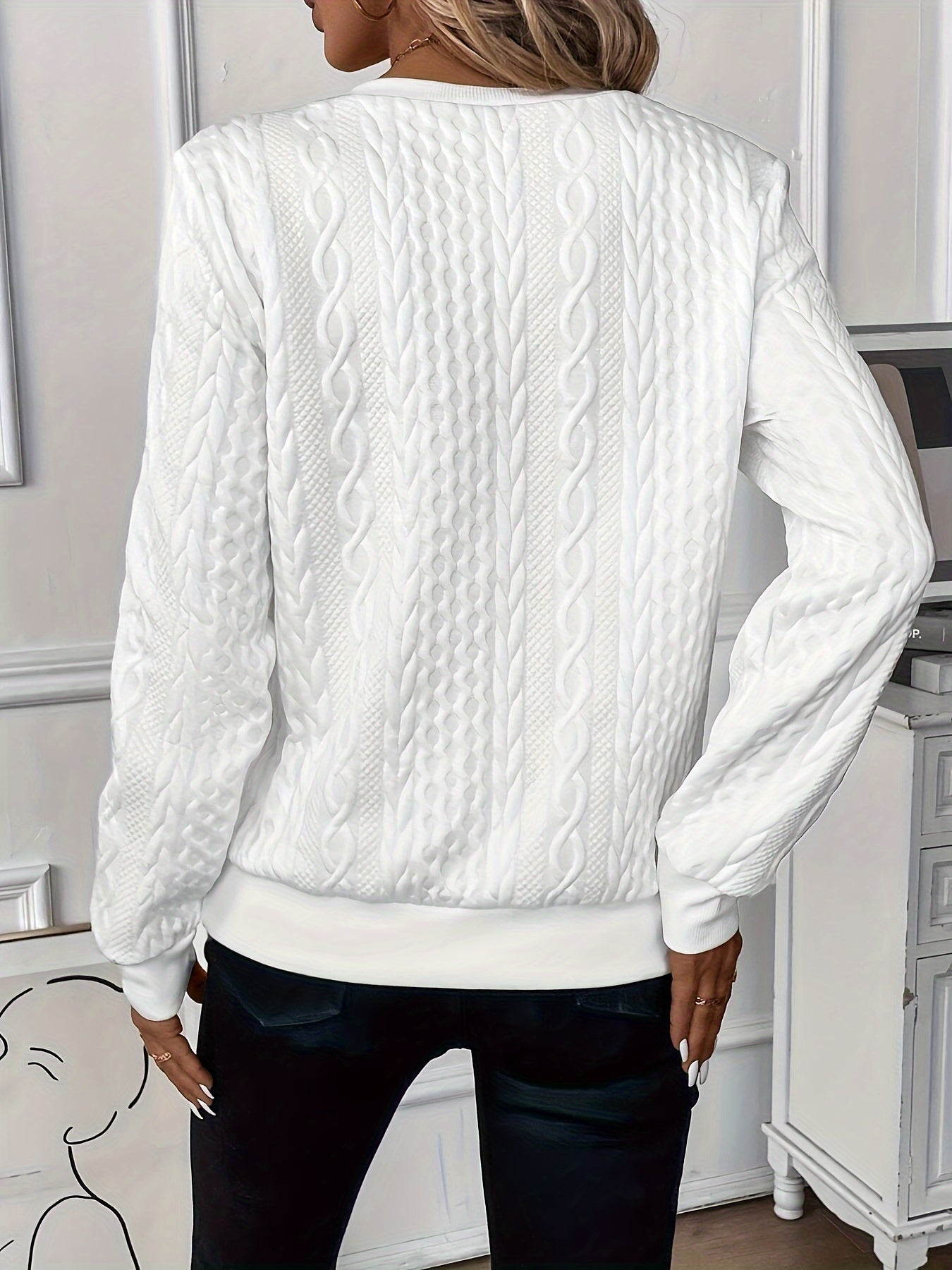 Woman wearing a cable knit quarter zip sweater