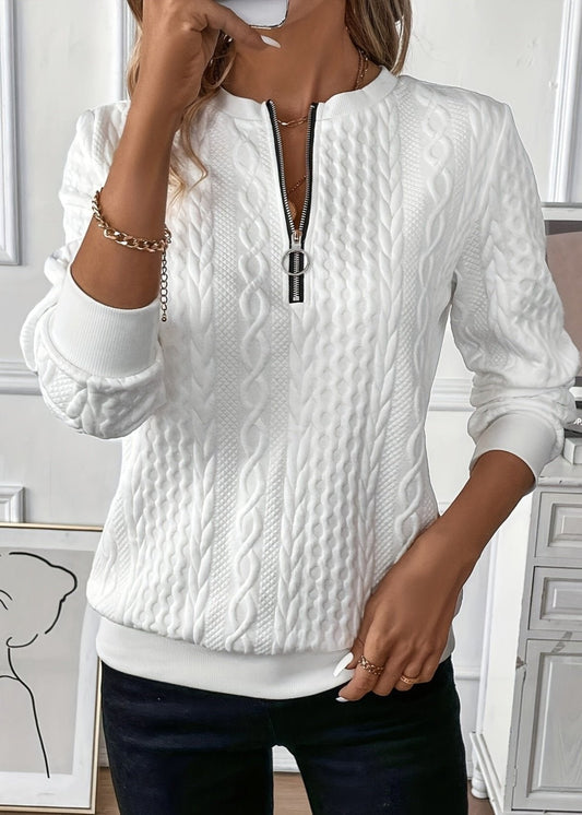 Woman wearing a cable knit quarter zip sweater