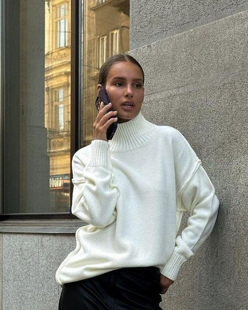 Woman wearing a textured oversized turtleneck sweater