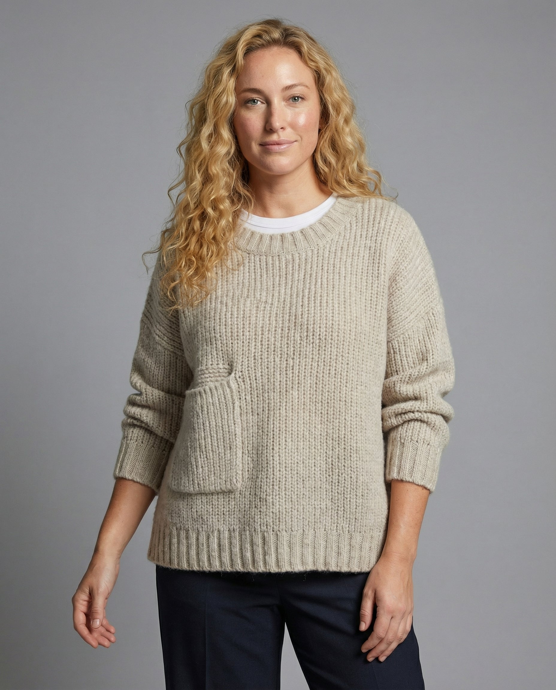 Woman wearing an oversized knit sweater with a front pocket