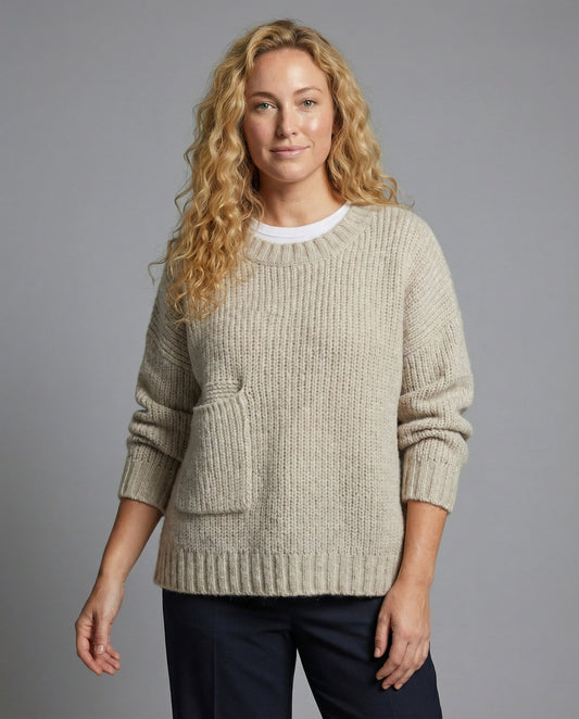 Woman wearing an oversized knit sweater with a front pocket