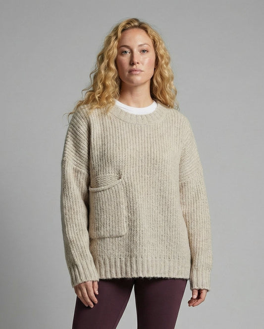 Woman wearing an oversized knit sweater with a front pocket