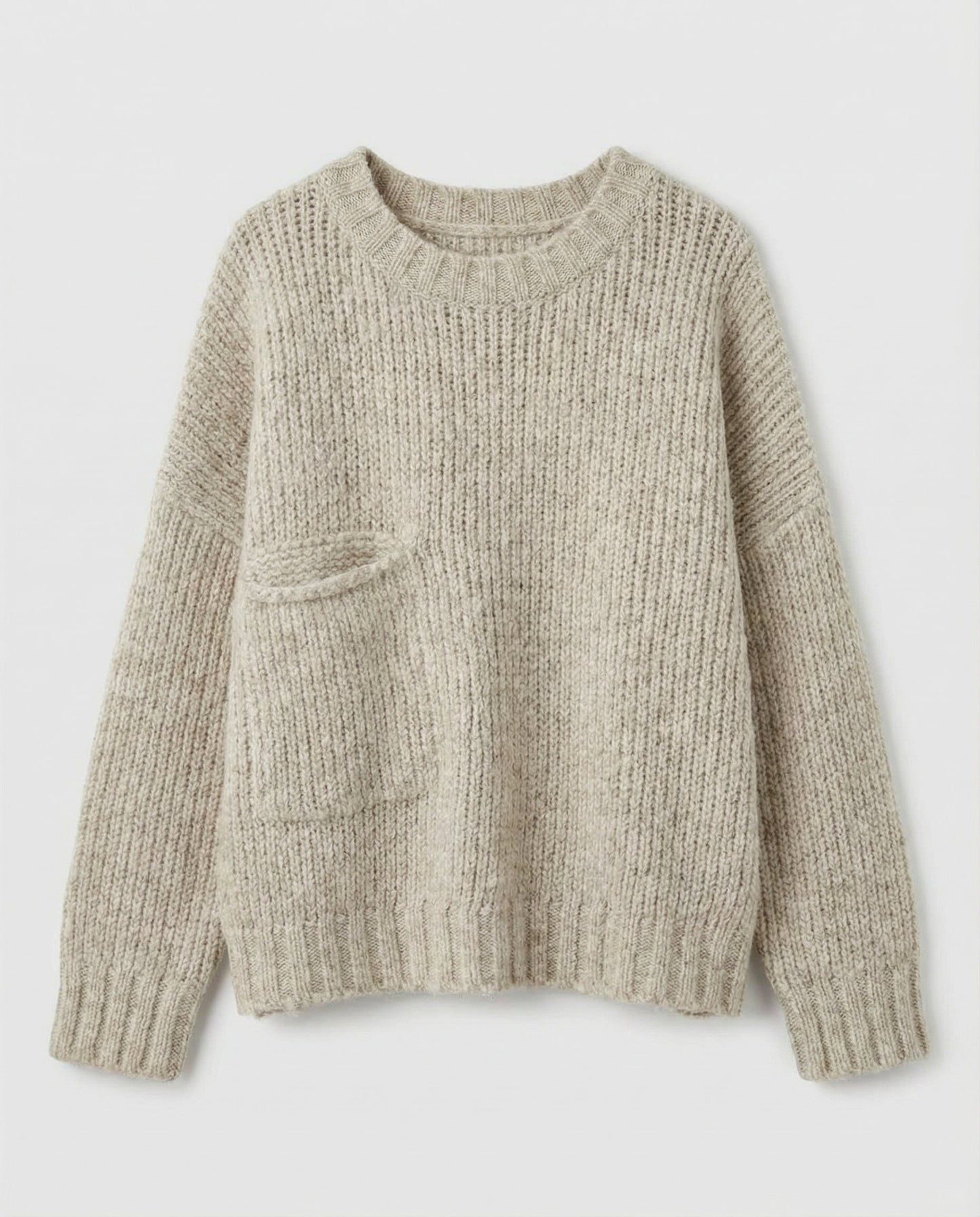 Woman wearing an oversized knit sweater with a front pocket