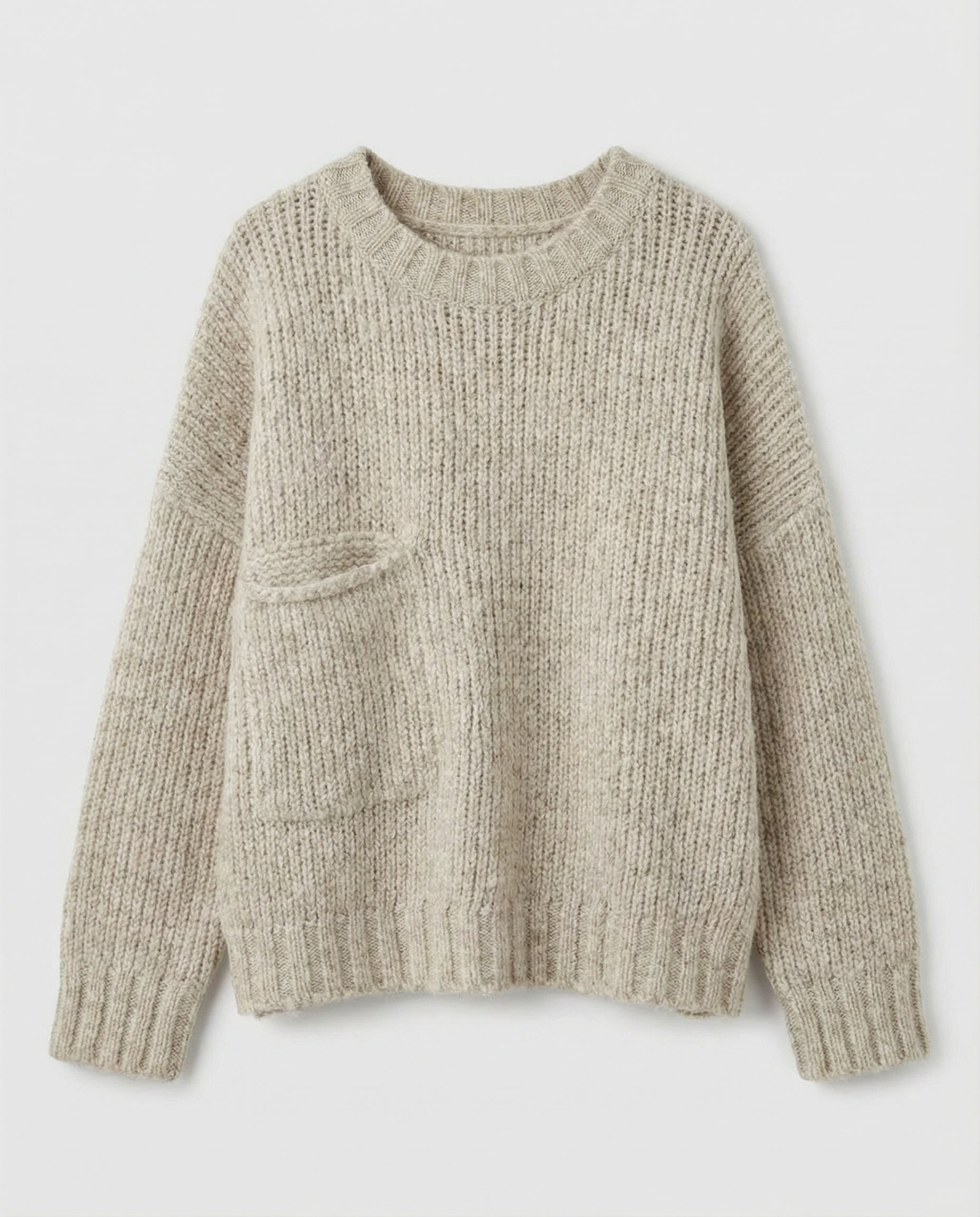 Woman wearing an oversized knit sweater with a front pocket