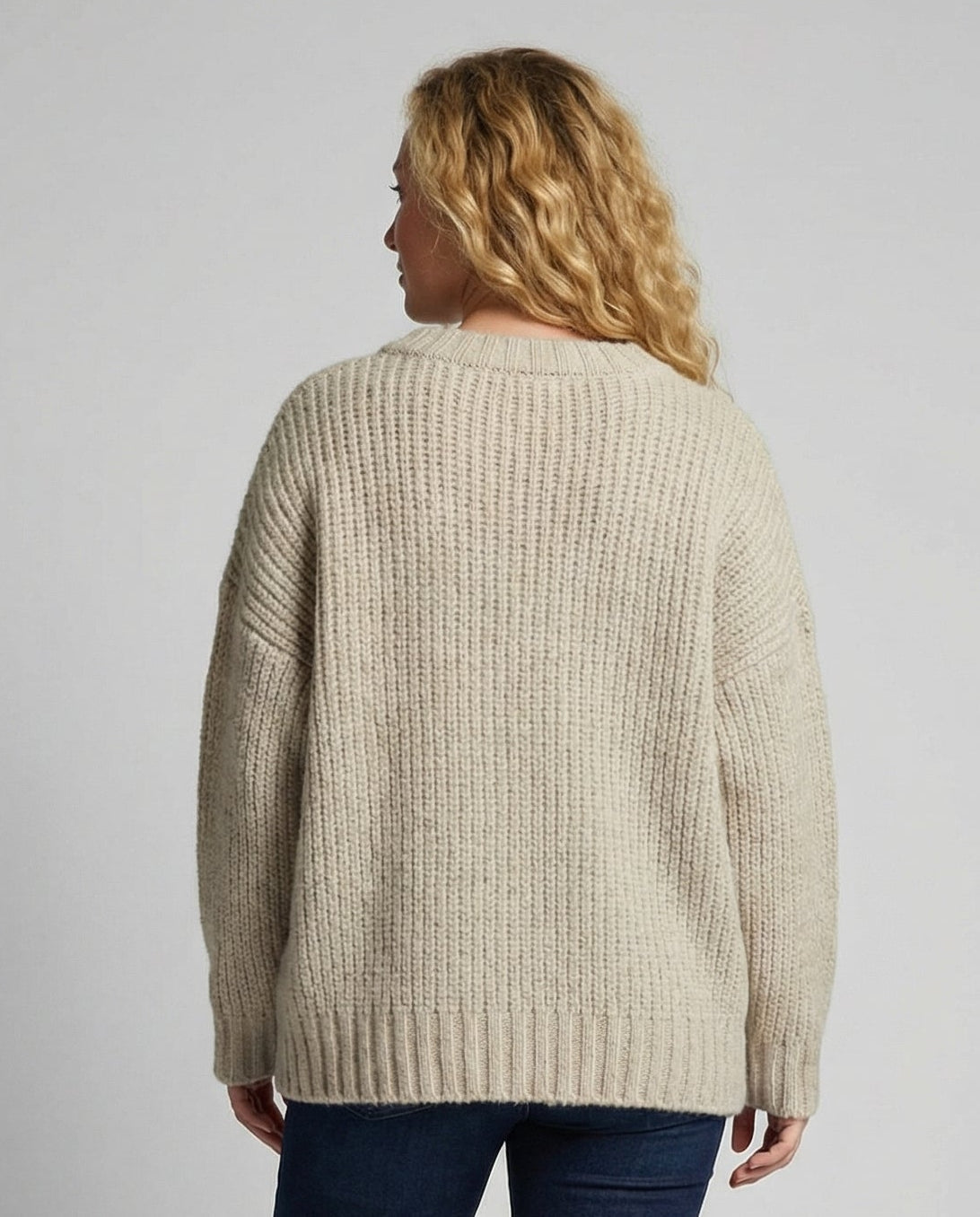 Woman wearing an oversized knit sweater with a front pocket