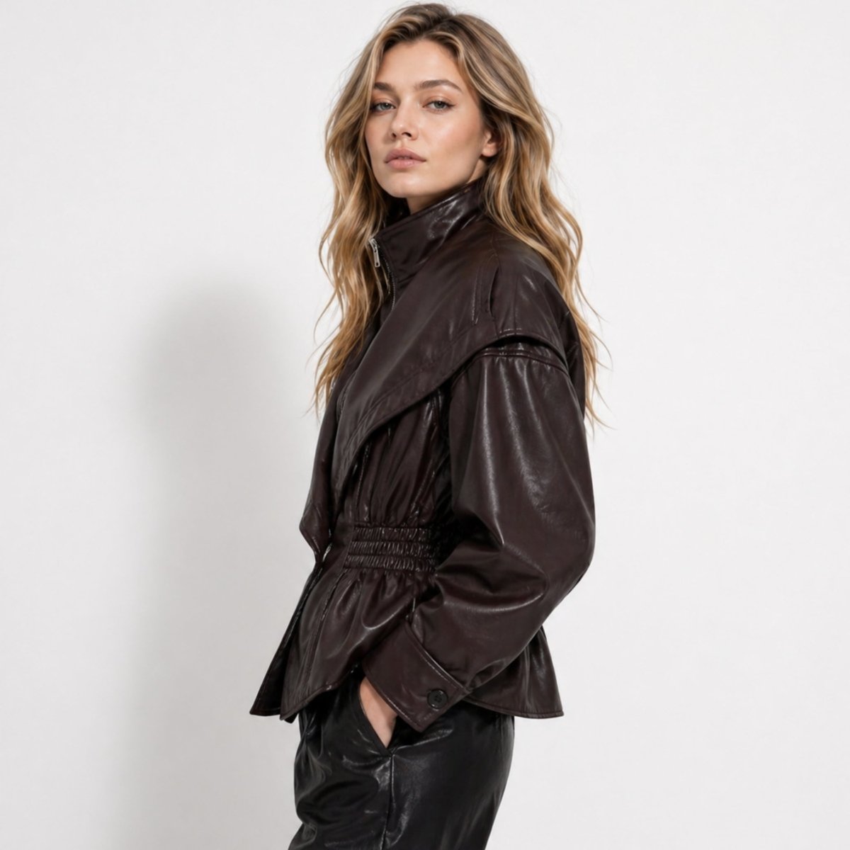 Woman wearing a cinched waist faux leather funnel neck jacket