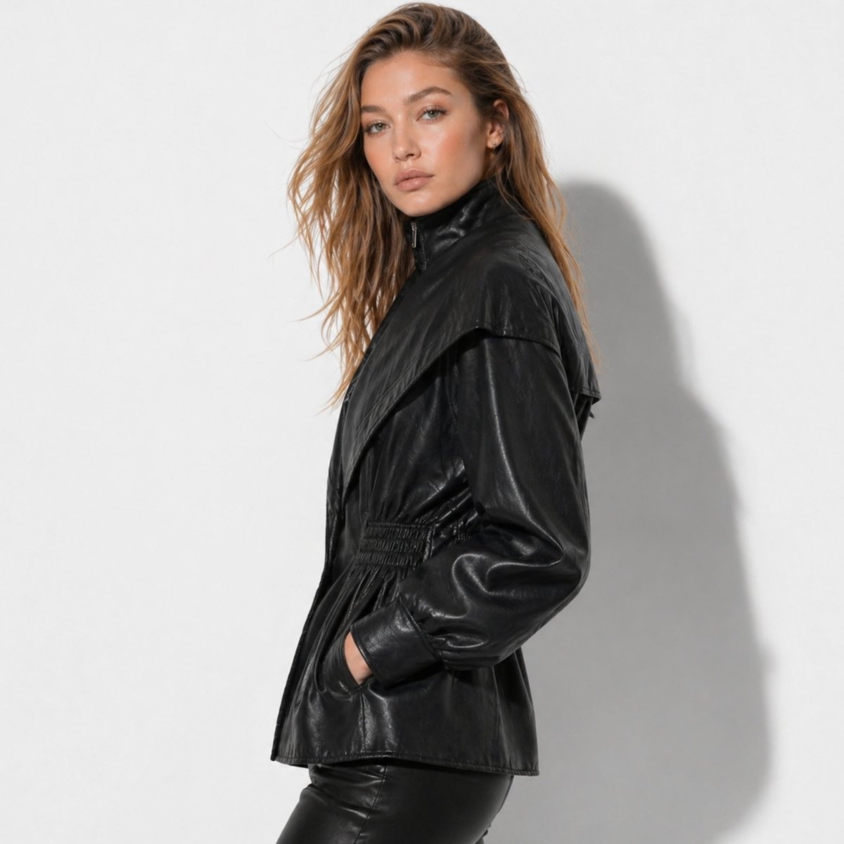 Woman wearing a cinched waist faux leather funnel neck jacket