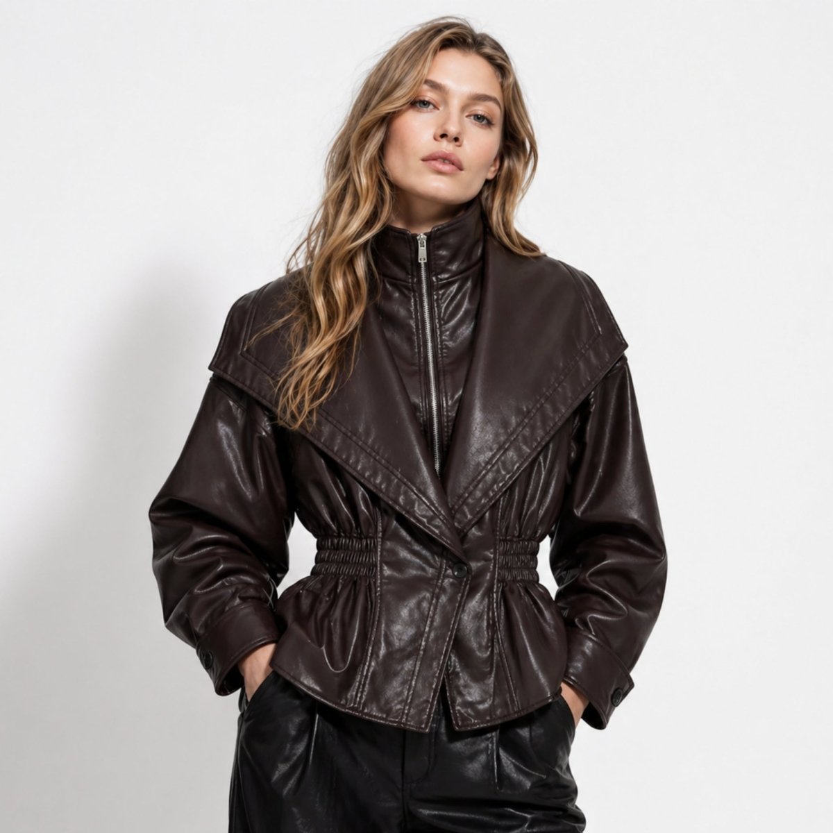 Woman wearing a cinched waist faux leather funnel neck jacket