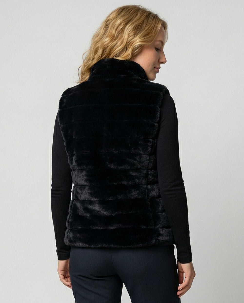 Woman wearing a faux fur quilted vest
