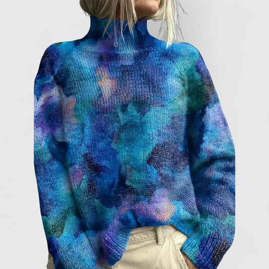 Woman wearing a printed turtleneck sweater with all-over artwork and ribbed cuffs