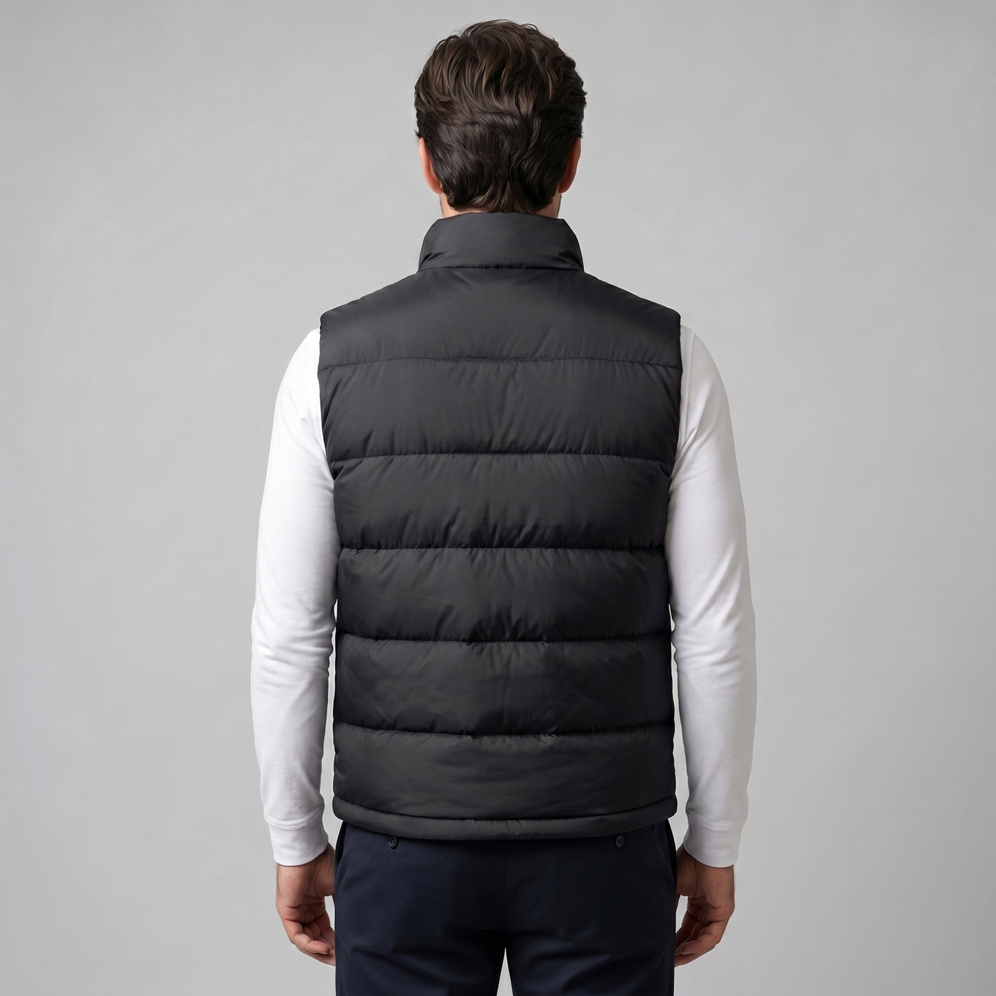 Man wearing a men's quilted puffer vest with a stand collar and full zip front
