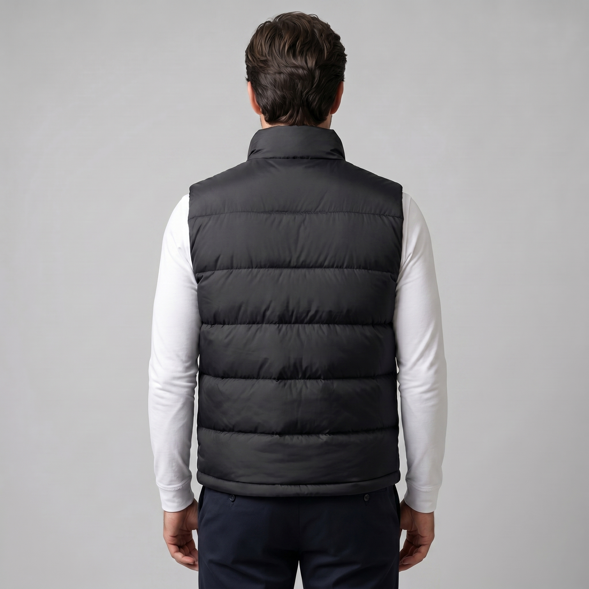 Man wearing a men's quilted puffer vest with a stand collar and full zip front