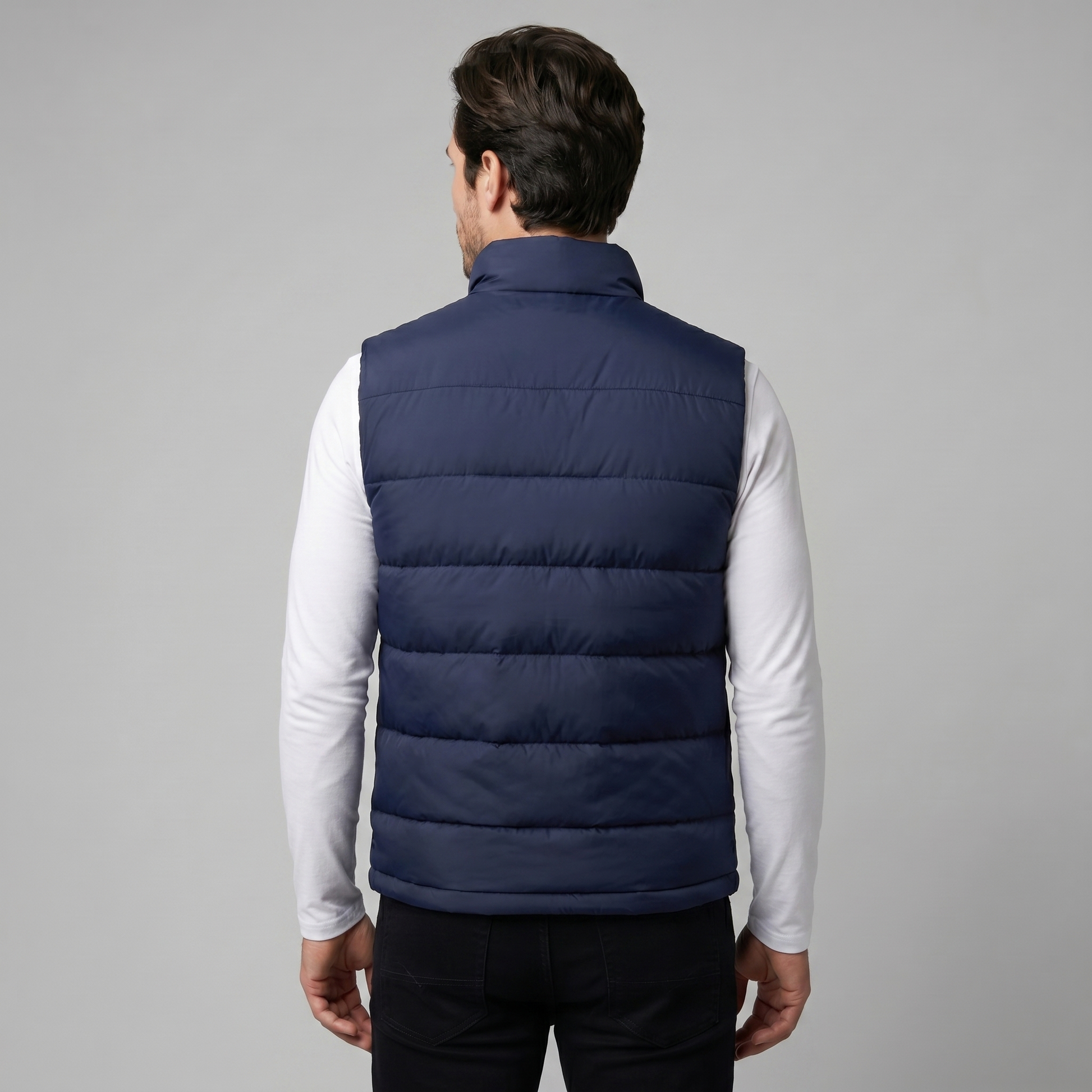 Man wearing a men's quilted puffer vest with a stand collar and full zip front