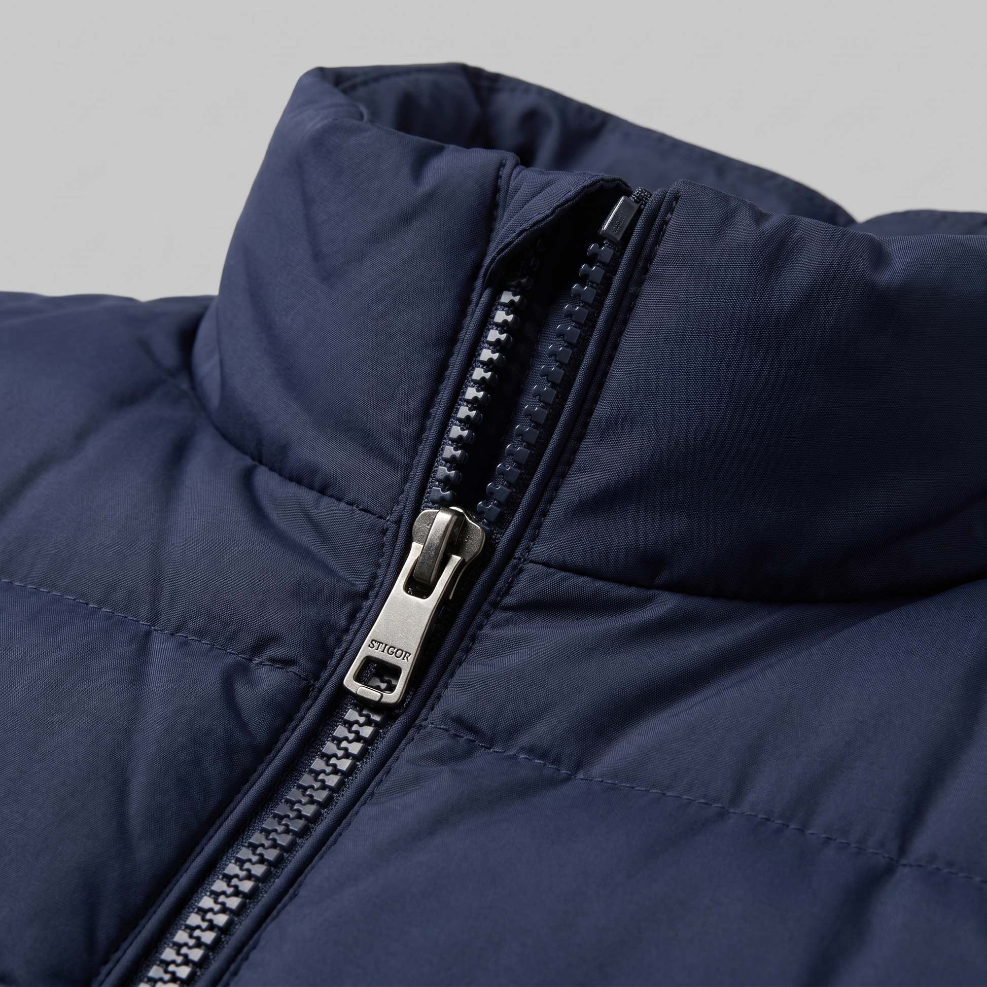 Man wearing a men's quilted puffer vest with a stand collar and full zip front