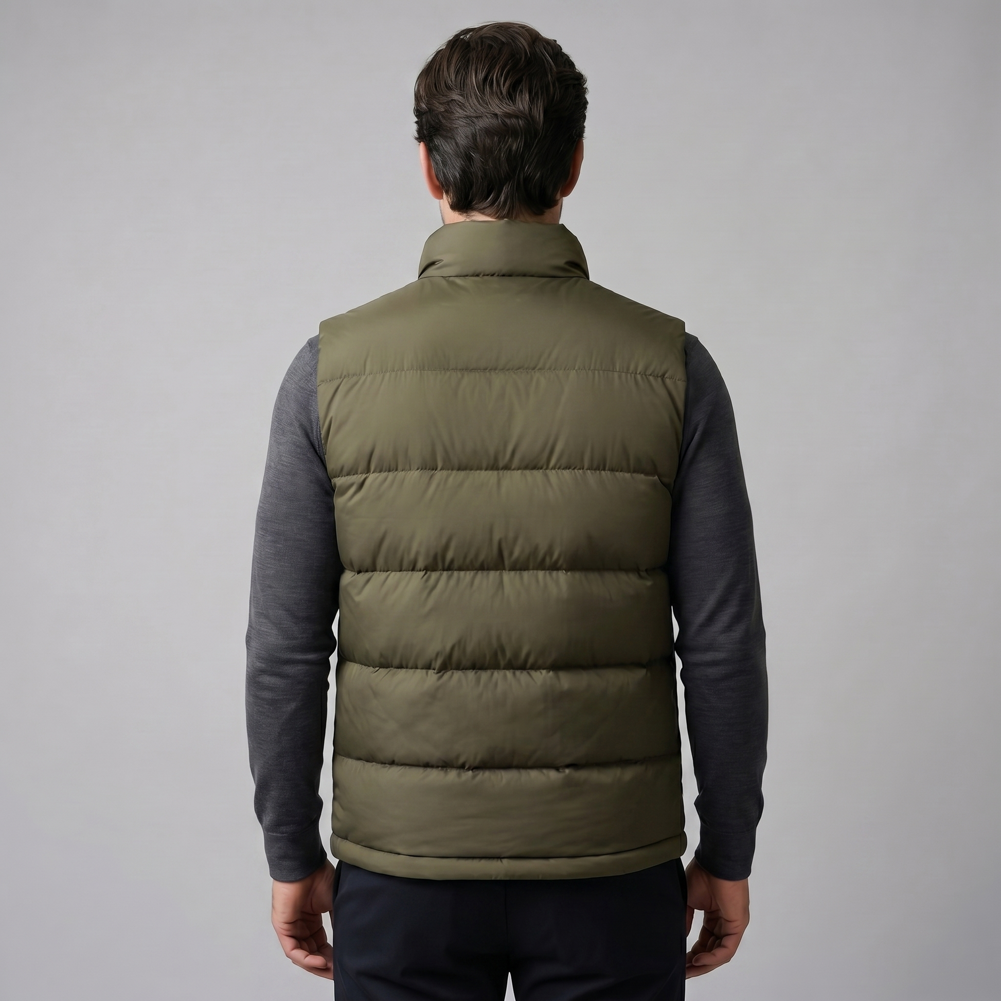 Man wearing a men's quilted puffer vest with a stand collar and full zip front