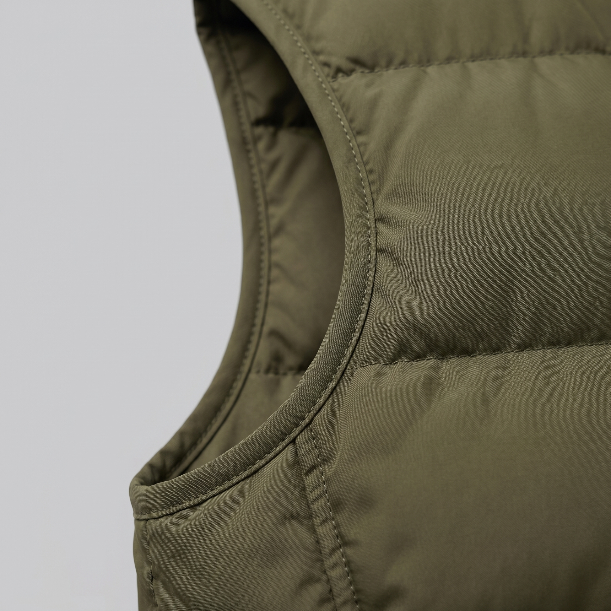 Man wearing a men's quilted puffer vest with a stand collar and full zip front