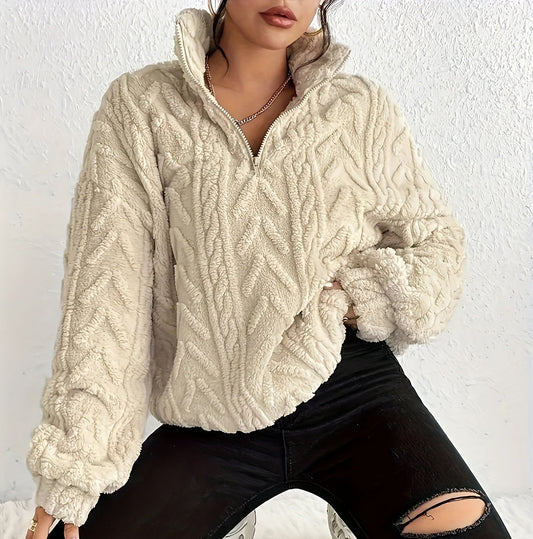 Woman wearing a cable knit fleece lined half zip sweater