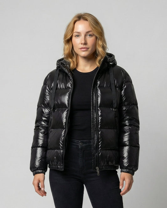 Person wearing a hooded quilted unisex puffer jacket