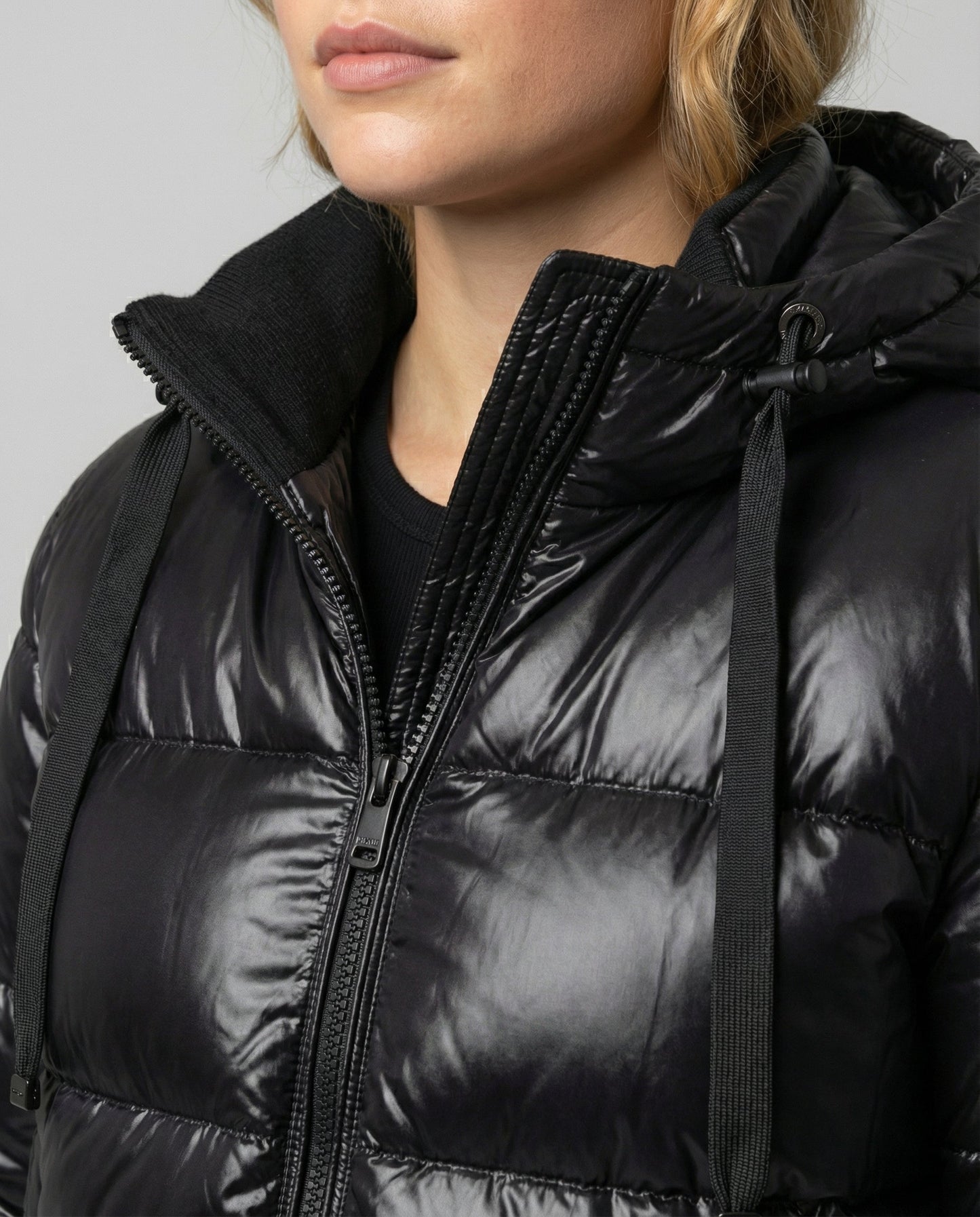 Person wearing a hooded quilted unisex puffer jacket