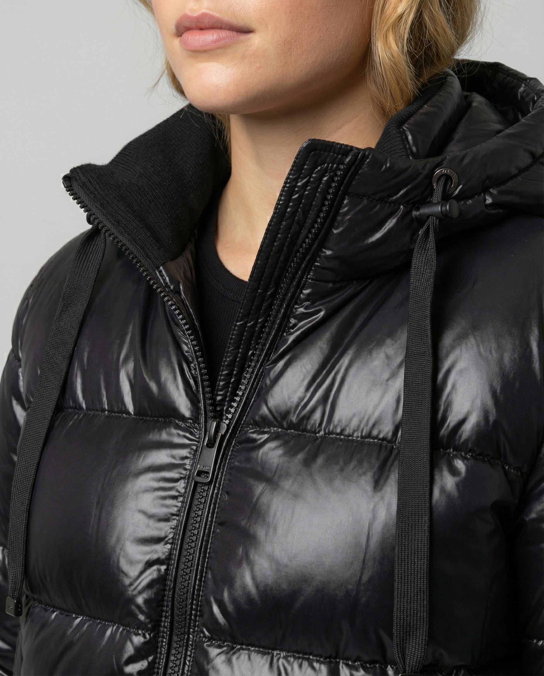 Person wearing a hooded quilted unisex puffer jacket