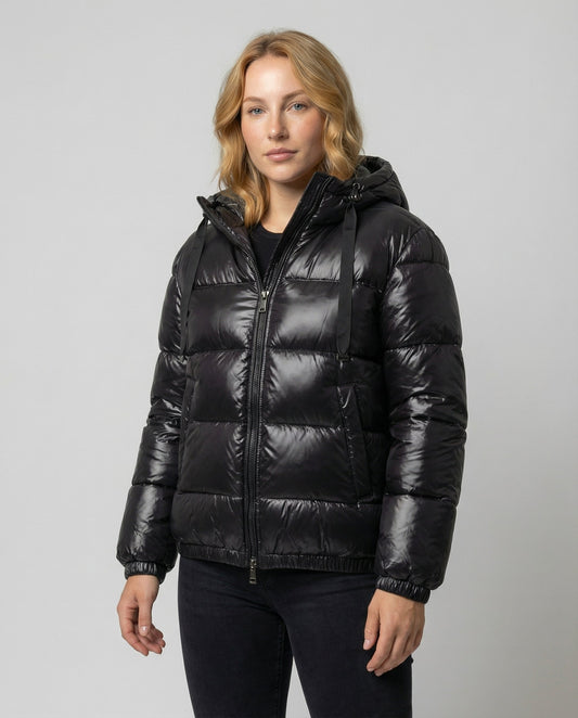 Person wearing a hooded quilted unisex puffer jacket