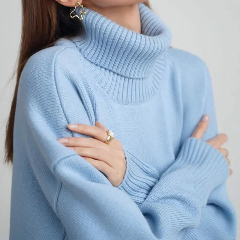 Woman wearing an oversized turtleneck knit sweater