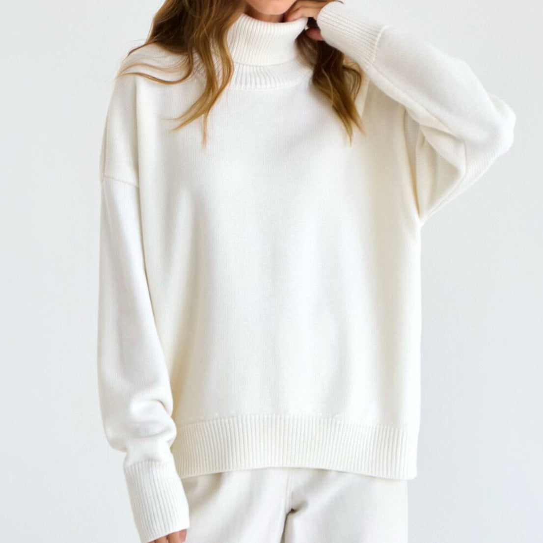 Woman wearing an oversized turtleneck knit sweater