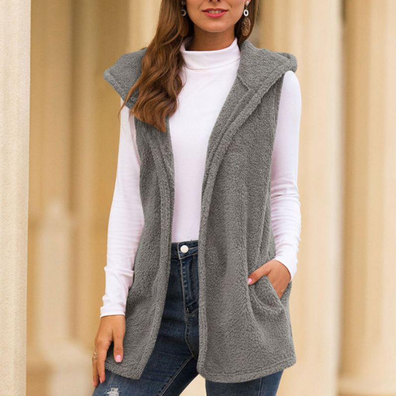 Woman wearing a hooded fleece vest with pockets