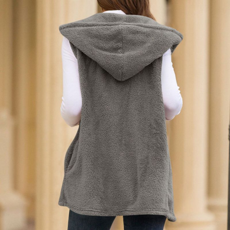 Woman wearing a hooded fleece vest with pockets