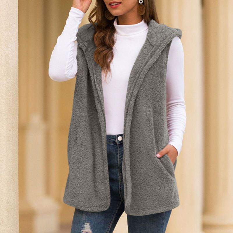 Woman wearing a hooded fleece vest with pockets