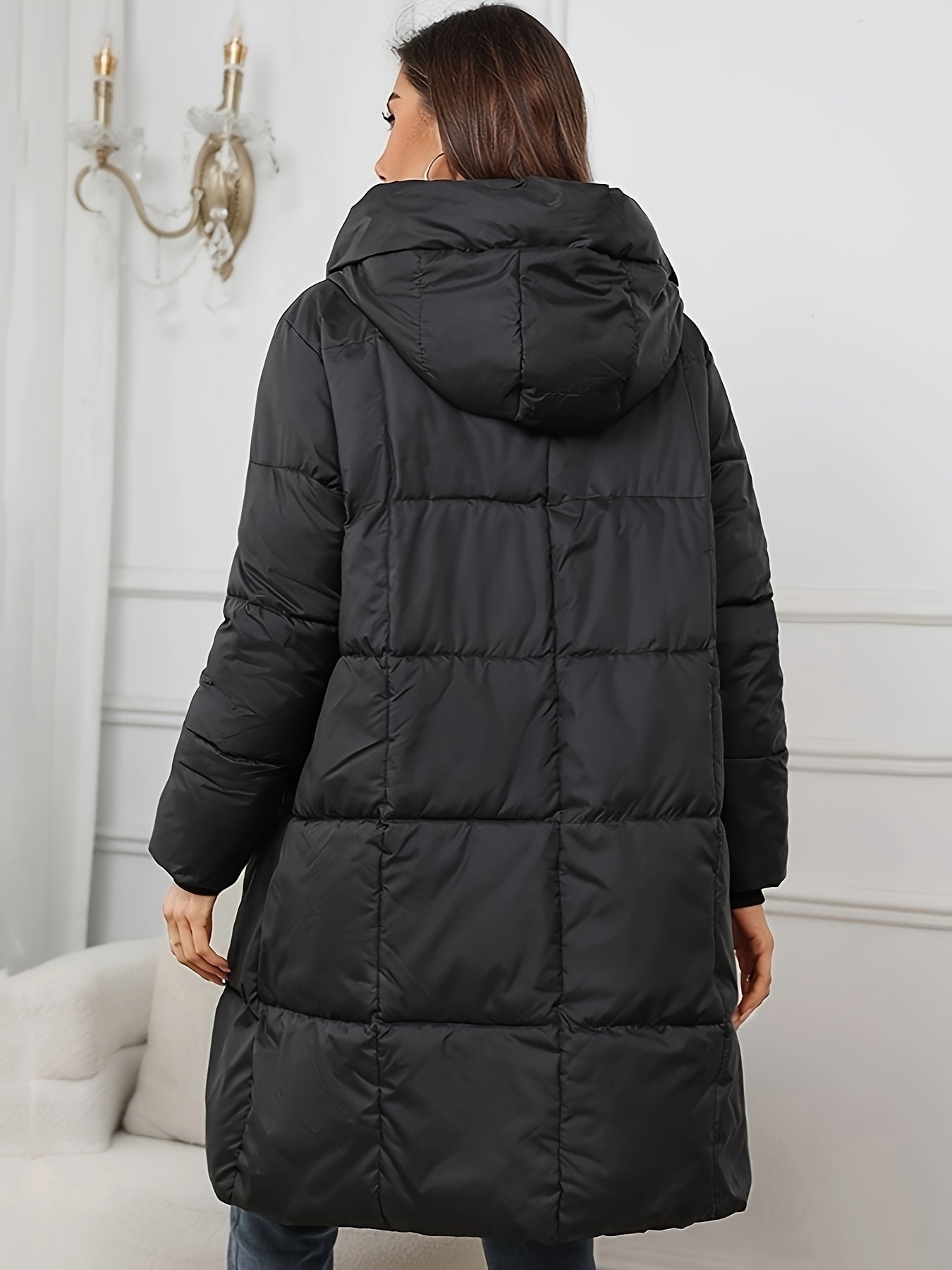 Woman wearing a mid-length hooded quilted puffer jacket