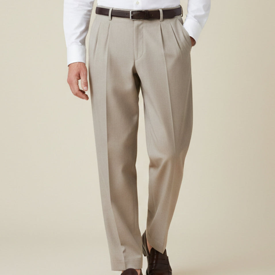 Man wearing formal pleated suit pants