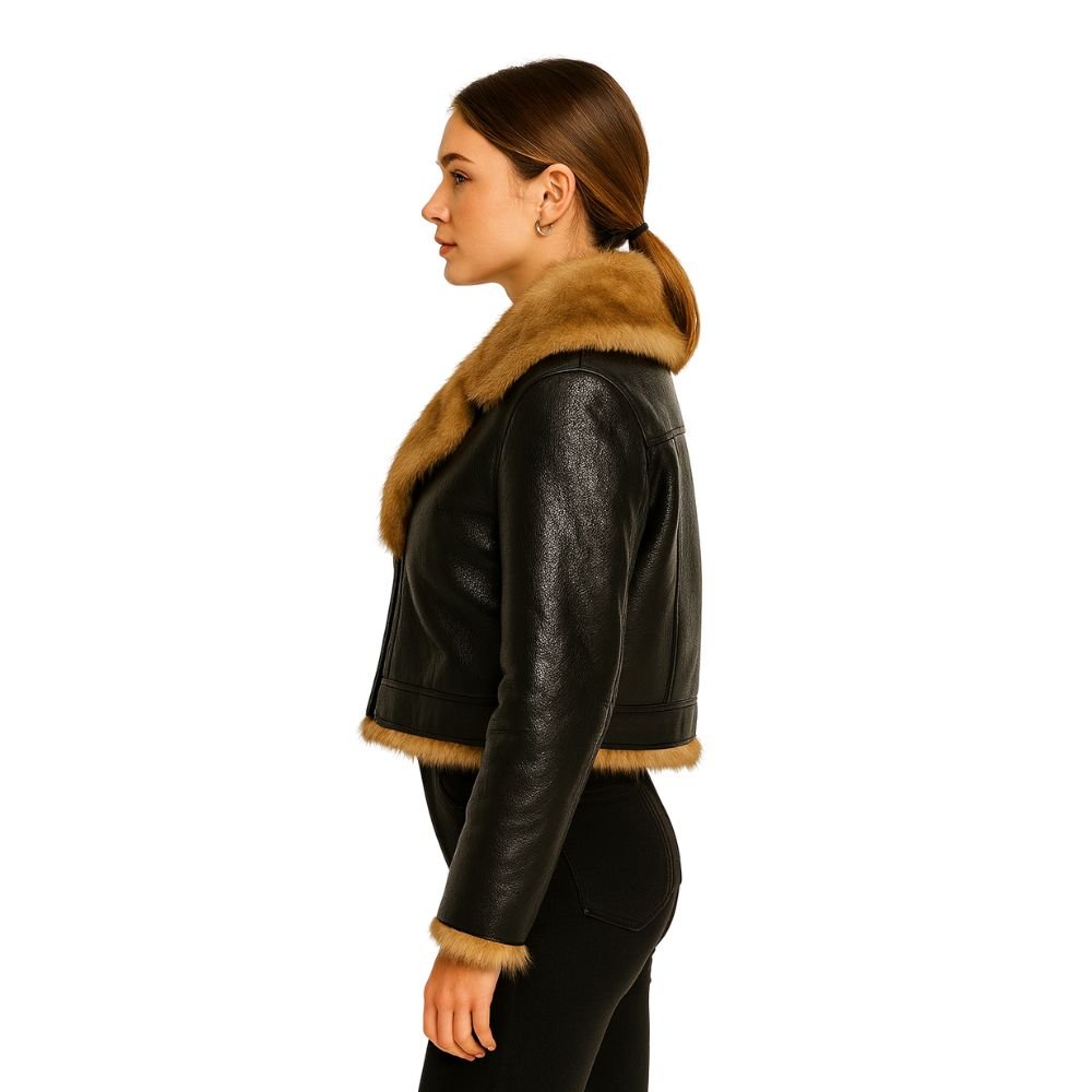 Woman wearing a cropped black faux leather aviator jacket with faux shearling collar
