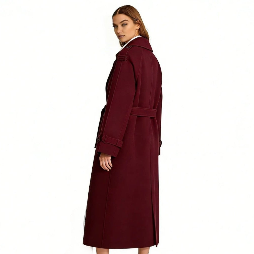 Woman wearing a long double-breasted belted trench coat